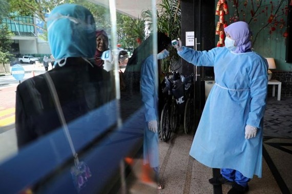 A nurse checks the temperature of a visitor as part of the coronavirus screening procedure at a hospital in Kuala Lumpur on Feb 3, 2020. (Photo: Reuters)