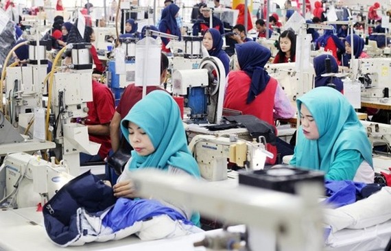 Workers operate sewing machines at a garment factory in Bogor, West Java. (Photo: Antara)