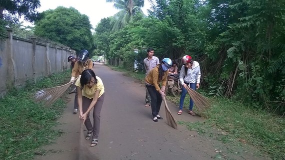 Đảng viên xã Trung Hòa, huyện Trảng Bom, tỉnh Đồng Nai vận động người dân tham gia làm vệ sinh môi trường