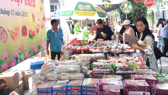 Khách hàng chọn mua các loại bánh mứt và đặc sản của tỉnh Đồng Tháp  tại phiên chợ “Tết xanh - quà Việt” tổ chức tại TPHCM từ ngày 17 đến 22-1