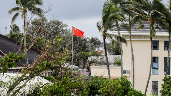 A Chinese flag flies outside the Chinese Embassy in Nuku'alofa, Tonga. China is pouring billions of dollars in aid and low-interest loans into the South Pacific, as part of a battle for power and influence in the region.   © AP