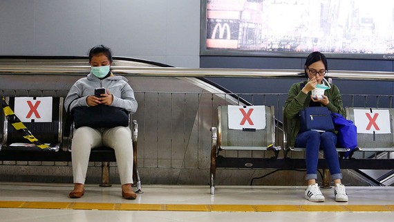 Benches at a station in Jakarta have been marked off to encourage social distancing.   © Reuters