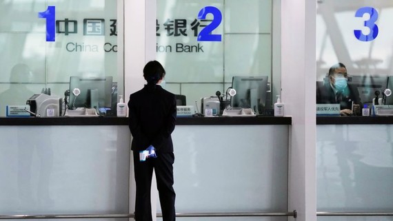 A branch of China Construction Bank in Wuhan. Data shows a lot of Chinese bank lending is not finding its way into the real economy as businesses and households hoard cash   © Reuters