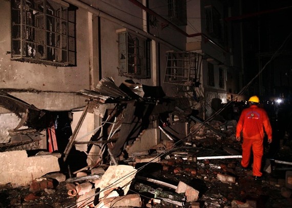 A Bangladeshi rescue worker walks through rubble and debris at a garment factory in Gazipur on Monday, after an explosion at the factory on the outskirts of Dhaka.