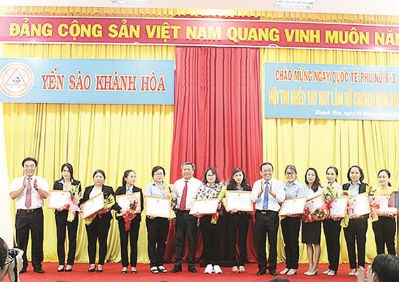 Ông Lê Hữu Hoàng - Chủ tịch HĐTV Công ty TNHH Nhà nước MTV Yến sào Khánh Hòa (người thứ 6 từ phải sang) tặng giấy khen cho nữ cán bộ, công nhân tiêu biểu
