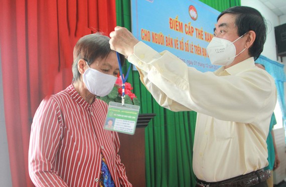 Ông Lê Văn Khanh, Chủ tịch Công ty TNHH MTV XSKT Sóc Trăng trao thẻ xanh cho người bán vé số dạo 