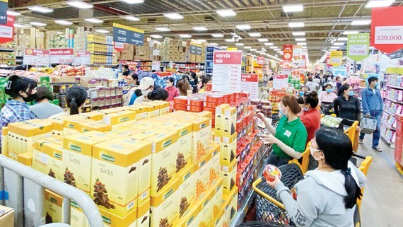 Customers go shopping at a supermarket. (Photo: SGGP)