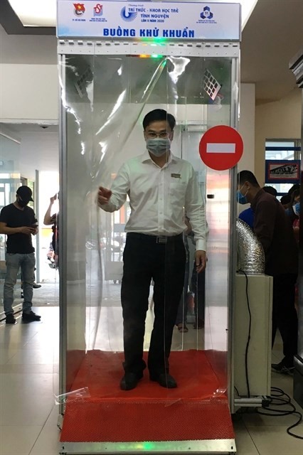 A man tries to use a mobile disinfection chamber at a launching ceremony held in HCM City on March 18. (Photo: VNA)