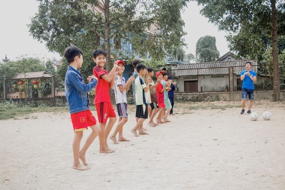 Children in Hue warm-up for football training. Photo Blue Dragon