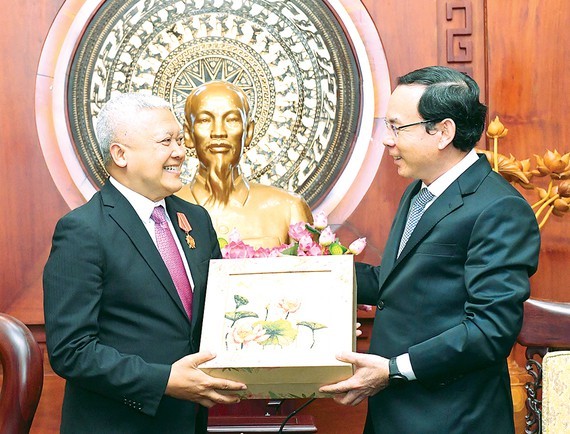 Secretary of the Party Committee of HCMC, Nguyen Van Nen (R) presents a gift to Indonesian Ambassador to Vietnam Ibnu Hadi. (Photo: SGGP)