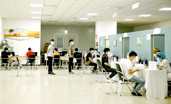 Doanh nghiệp sẽ trang trải chi phí vaccine cho công nhân Công nhân Công ty Điện tử Samsung Electronic Việt Nam thuộc KCN Yên Phong, Bắc Ninh khám sàng lọc trước khi tiêm vaccine Covid-19. Ảnh: MẠNH CƯỜNG