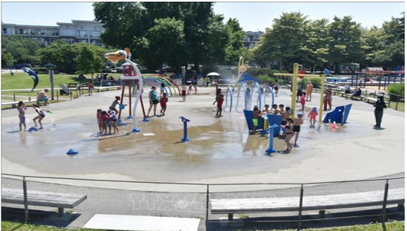 Trẻ em giải nhiệt tránh nóng tại một công viên nước ở Richmond, British Columbia, Canada ngày 29-6. Ảnh: AFP/TTXVN